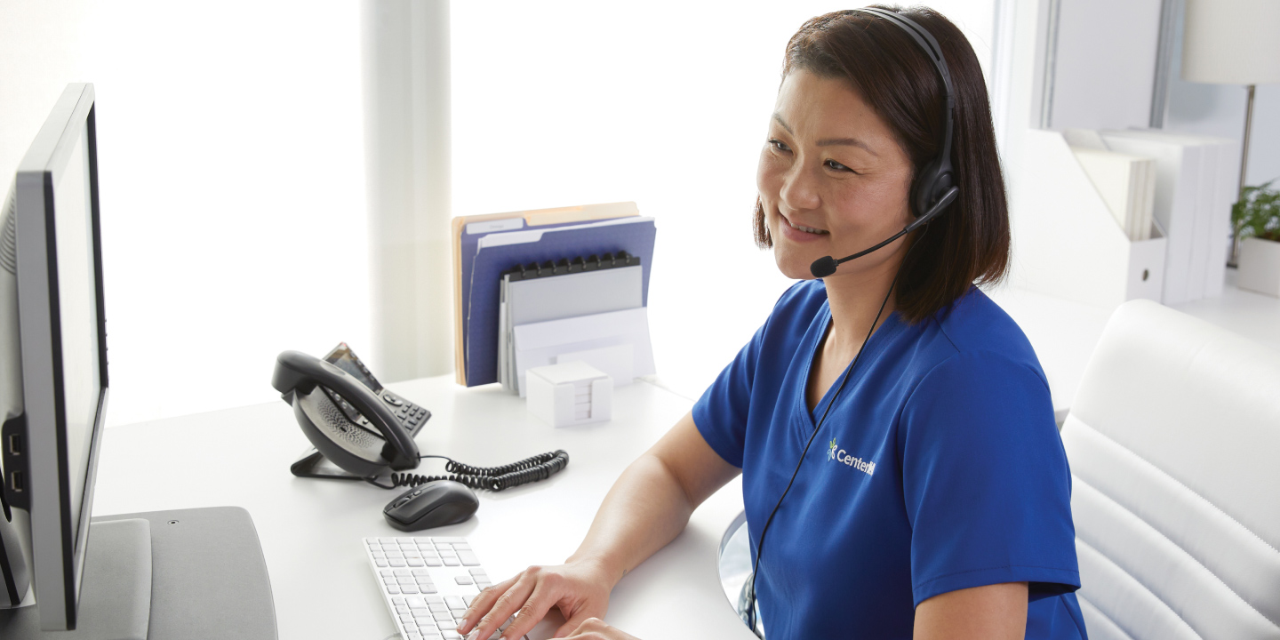 Female clinician happily receives patient calls at the office